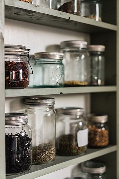 Glass storage jars lined up on a shelf