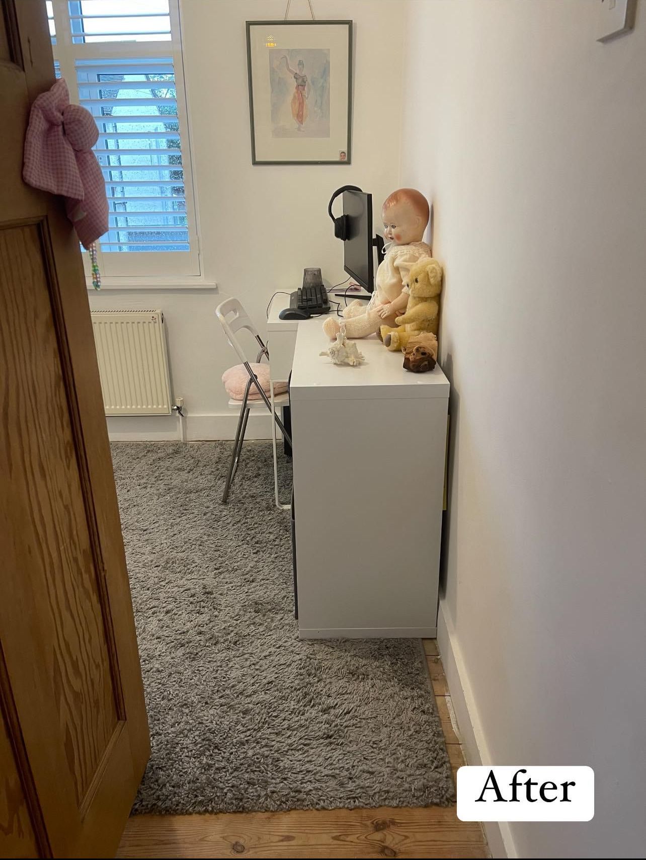 After: the bedroom with a clear carpet and a tidy white desk and chair under the window
