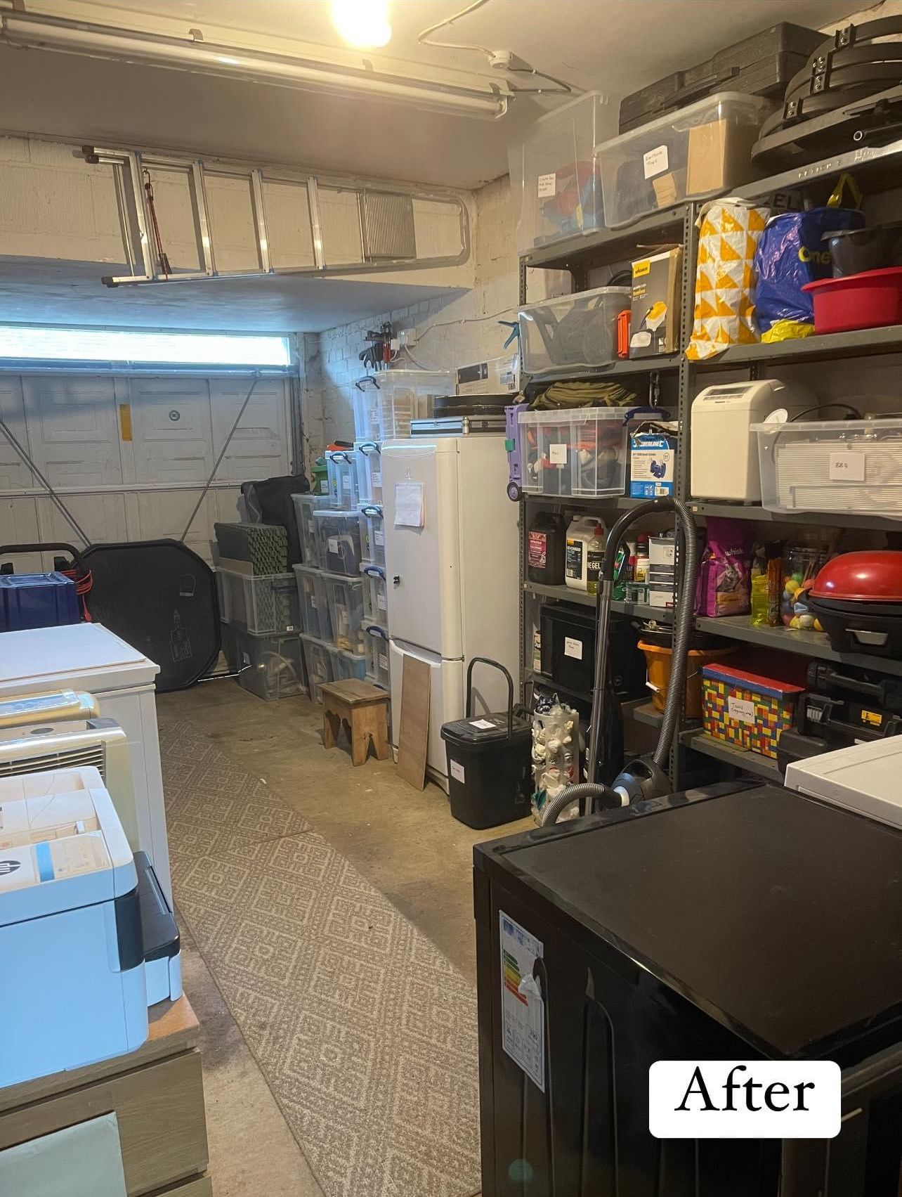 After: the garage with shelves of labelled tubs and food stores, appliances along the walls and a clear path down the middle