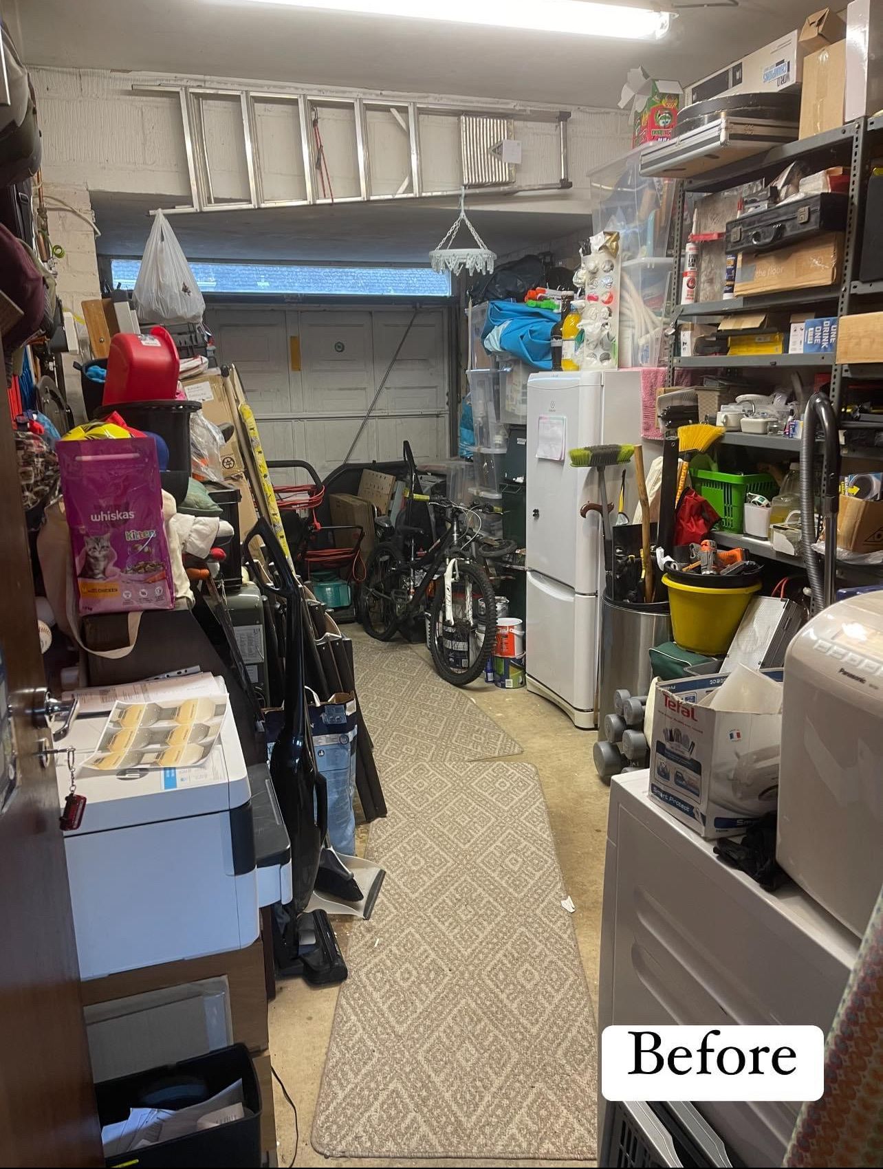 Before: a garage crowded with bikes, bags, tools and boxes on every side of a narrow path