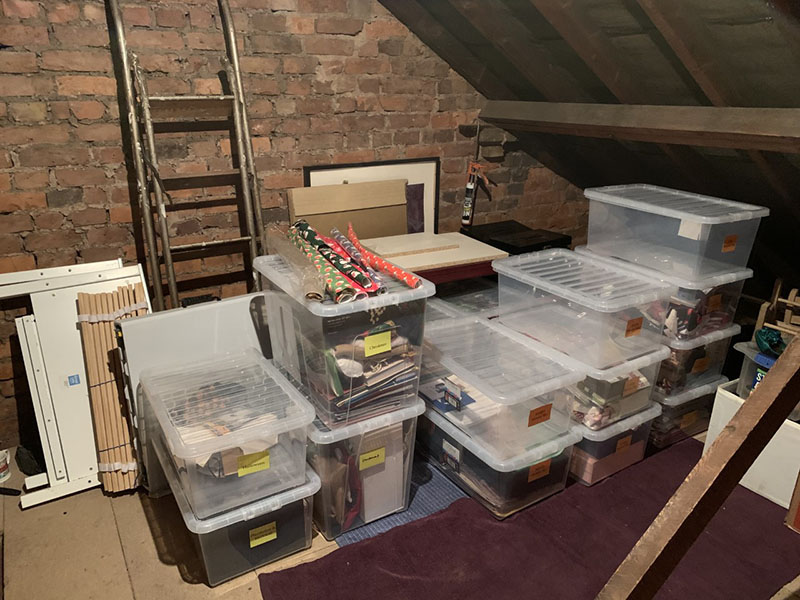 Organised loft area, everything has been organised into labelled boxes, or otherwise organised neatly